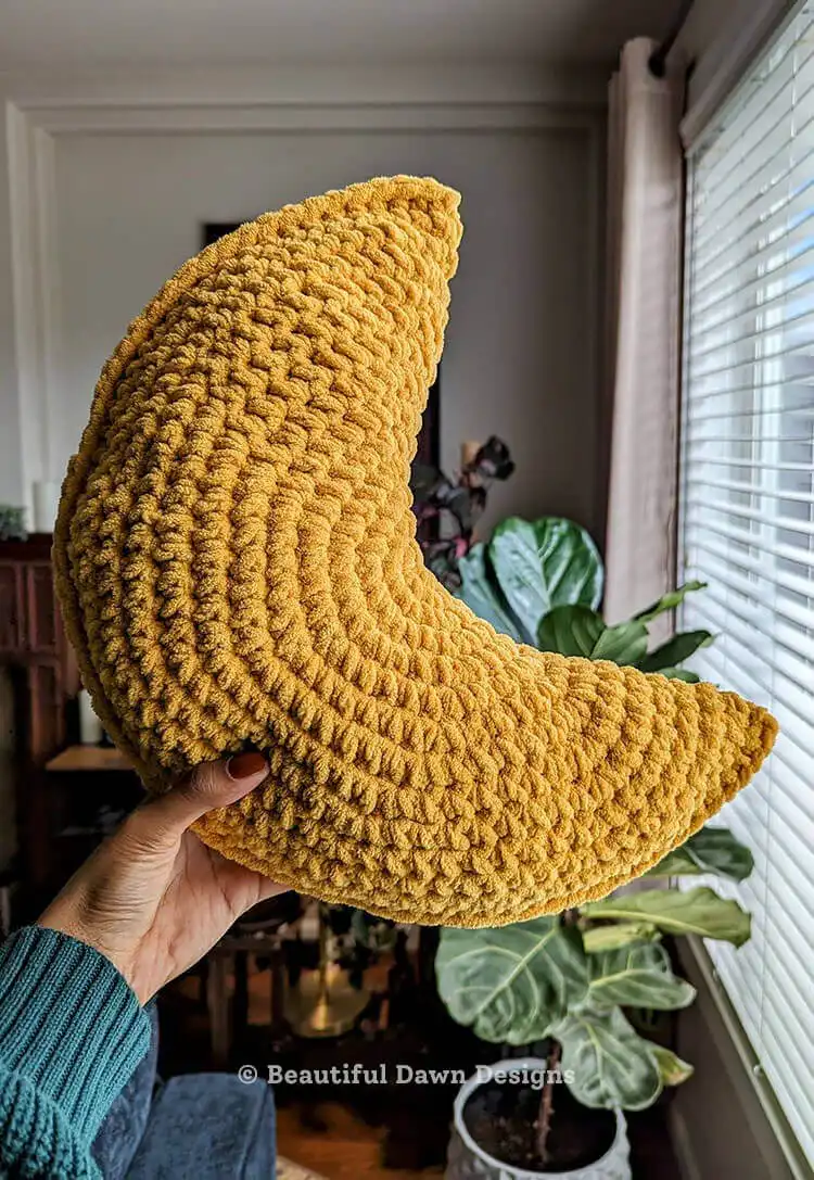 Crochet project in progress, showing rounds of single crochet stitches forming a circular base for the moon pillow. Moon Pillow Crochet Pattern steps.