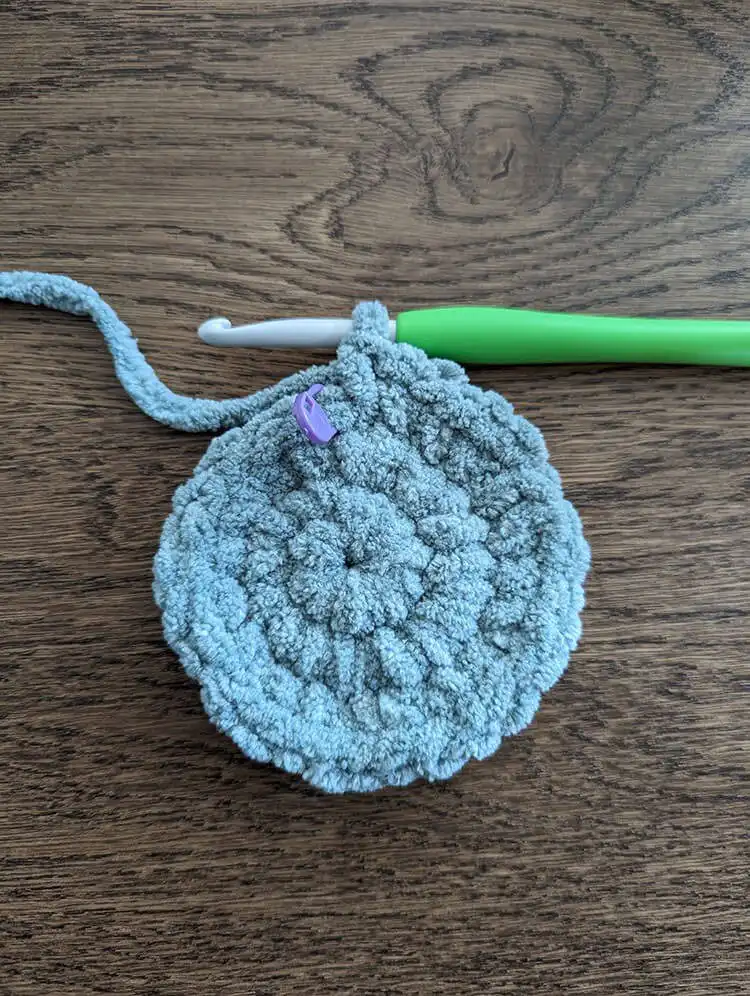 Detailed view of the crochet fabric as it begins to undulate, indicating the correct shaping for the crescent moon pillow. Moon Pillow Crochet Pattern guide.