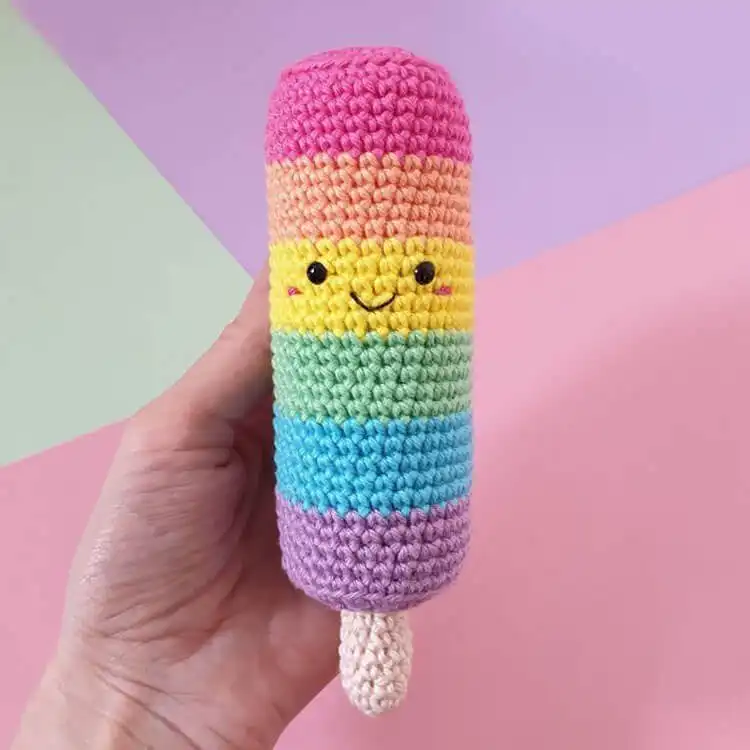 No-Sew Amigurumi Crochet Patterns No-Sew Bronto 15 A colorful no-sew Kawaii Popsicle crochet toy with pink and yellow stripes on a stick.