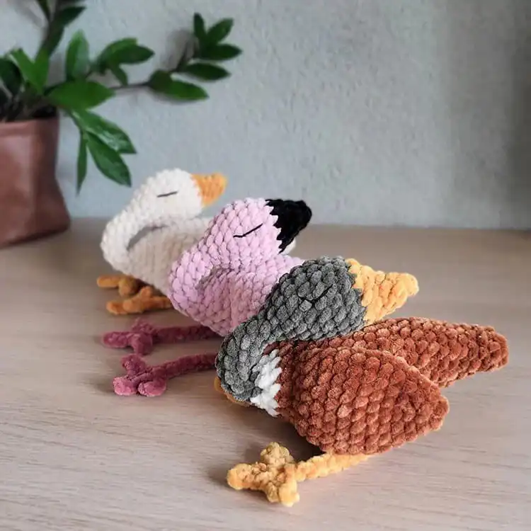 No-Sew Amigurumi Crochet Patterns No-Sew Bronto 19 A peaceful white no-sew Snoozing Goose amigurumi with closed eyes, appearing to be asleep.