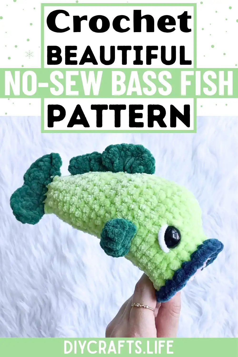 Materials and tools spread out for the No-Sew Crochet Bass Fish Design, including yarn, hook, safety eyes, and stitch markers.