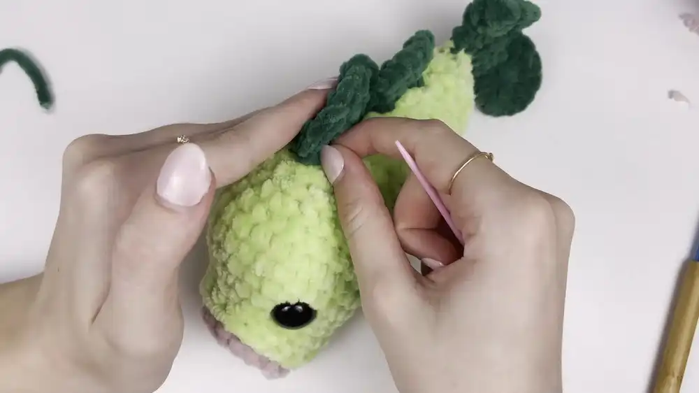 Partially stuffed crochet bass fish body showing the gradual decrease rounds towards the tail end.