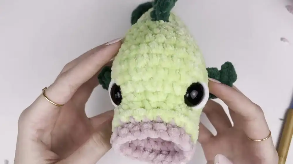 Close-up of the distinctive curved tail fin of the No-Sew Crochet Bass Fish, showing its textured bumps.