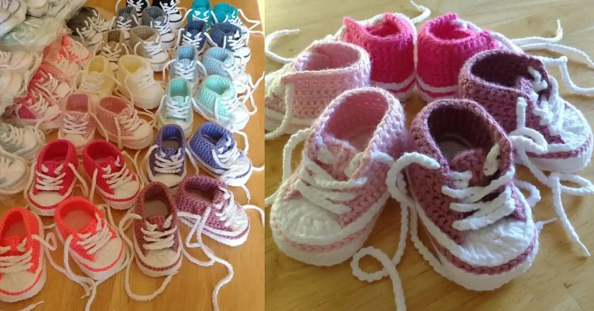 Collection of colorful crocheted Converse baby booties displayed on a wooden surface, ready for little feet.
