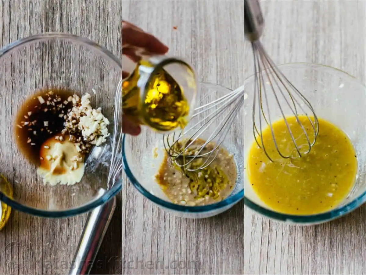A close-up of a whisk emulsifying Caesar salad dressing ingredients in a bowl, showing the smooth, creamy consistency.