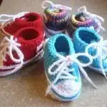 Colorful assortment of crocheted Converse sneaker-styled baby booties with laces, suitable for all occasions.