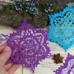A simple yet charming 'Crochet Snowflake Ornament' in white, displaying its star-shaped lacy design suitable for beginners.