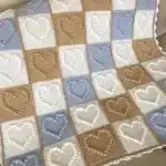 Tweed & True Baby Blanket in Tunisian crochet with beautiful ombre yarn transitions, offering plush, cozy comfort.
