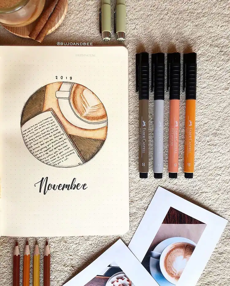 Illustration of an open book next to a steaming latte, perfect for a cozy November bullet journal theme