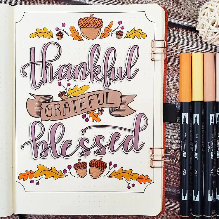 Festive 'Happy Thanksgiving' page with fruits, flowers, and fall leaves for a November bullet journal