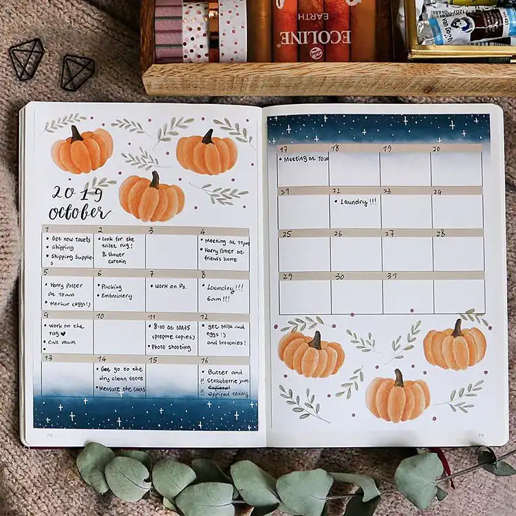 Elegant October bullet journal calendar with watercolor pumpkins and a starlit night sky, perfect for a sophisticated fall spread.