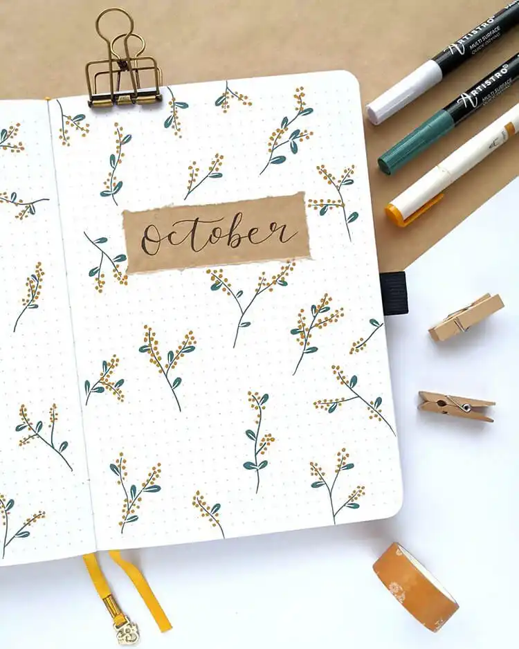 Bloomtober bullet journal page featuring illustrations of plants and flowers that bloom in the fall season.