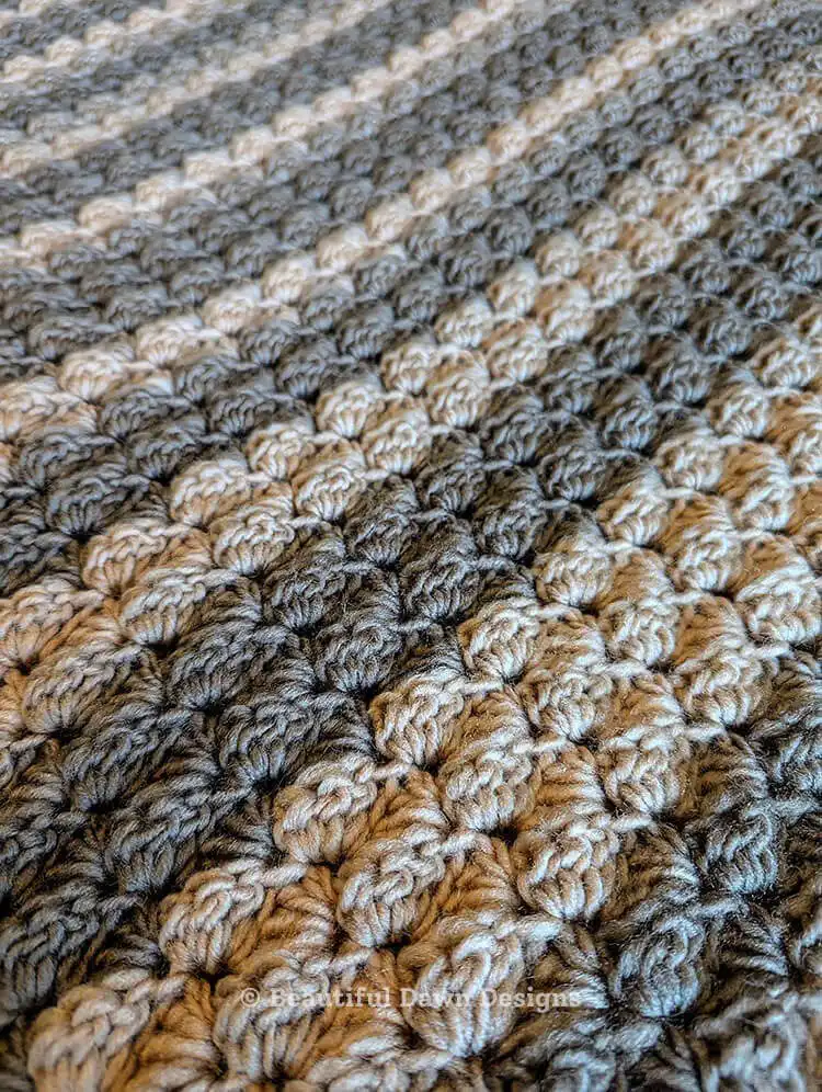 One-Row Repeat Easy Crochet Blanket Pattern - Crochet Throw Blanket draped over a chair, highlighting its size and drape