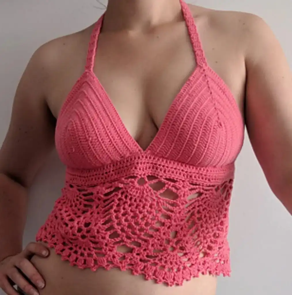 Pink boho crochet halter top with a solid upper section and intricate pineapple lace lower pattern.