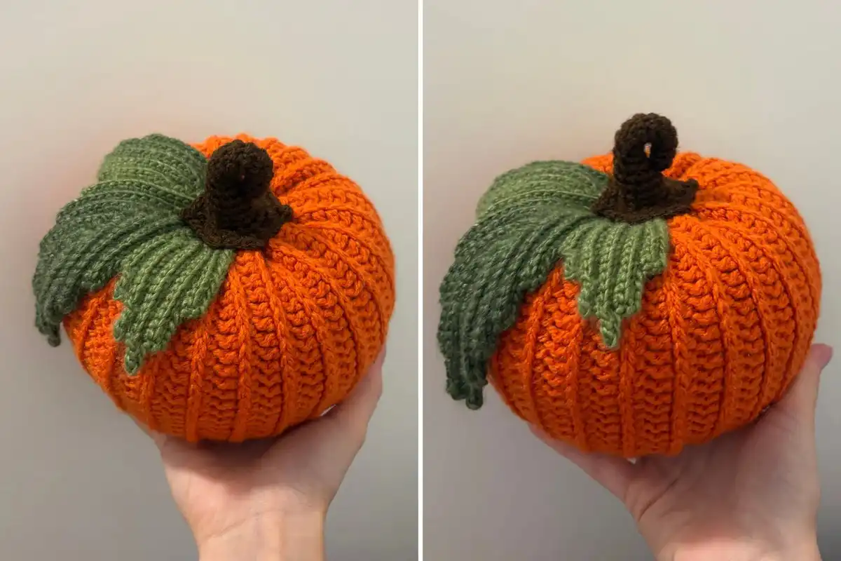 Weronika Miechowicz's hand holding a finished orange crochet pumpkin, demonstrating its size and texture.