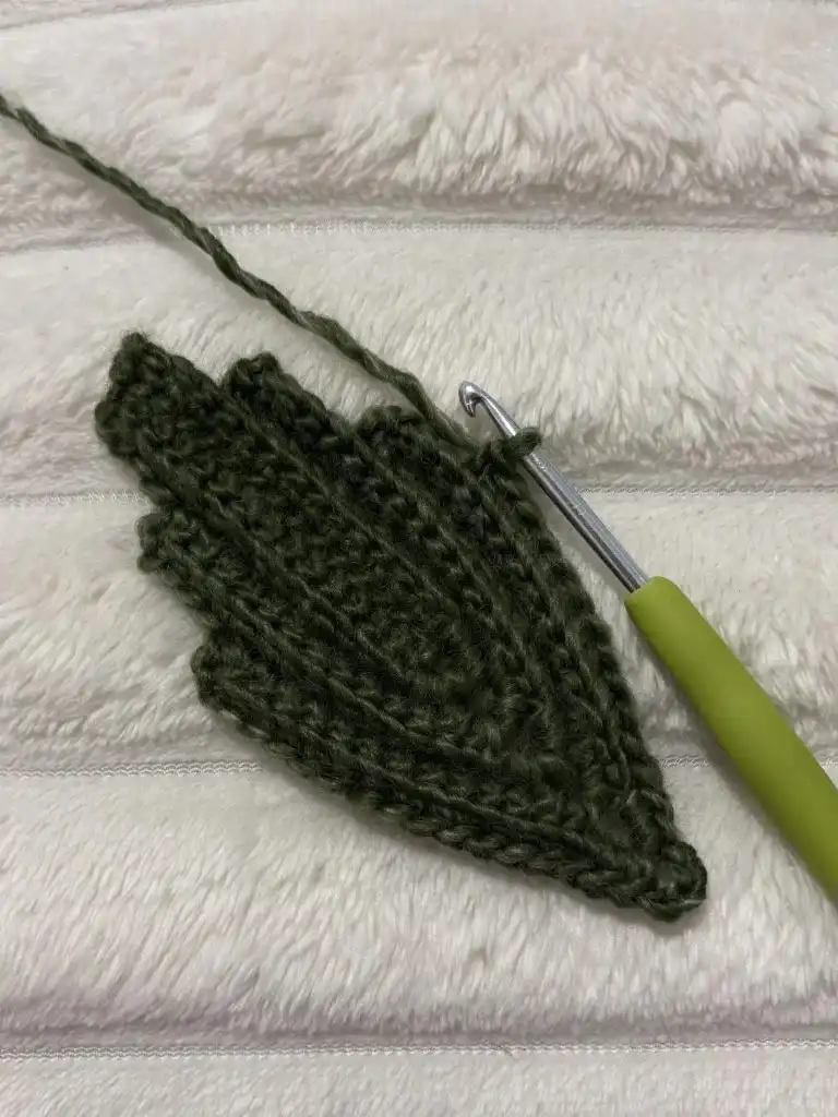 A completed green crochet leaf for the Pumpkin Free Crochet Pattern, showcasing its intricate design.