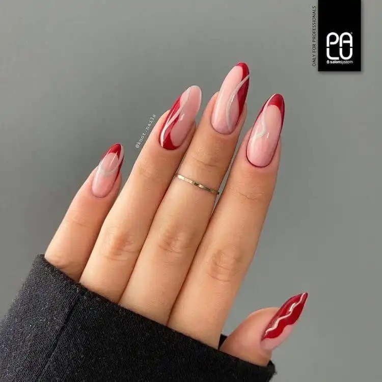 Unique red and black animal print acrylic nails, showing a creative take on traditional leopard spots.