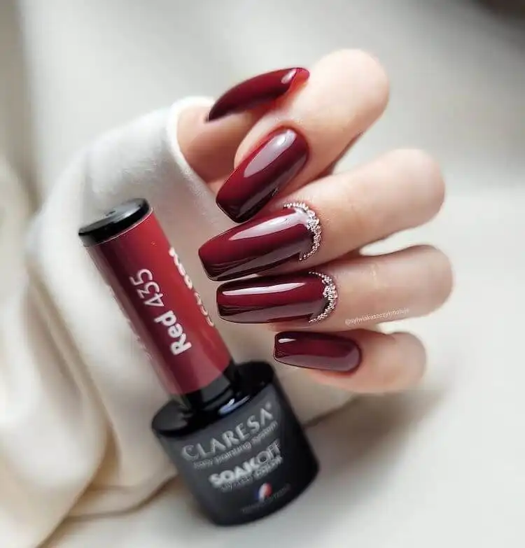 Beautiful, perfectly polished solid red acrylic nails, showcasing classic elegance and vibrant color.