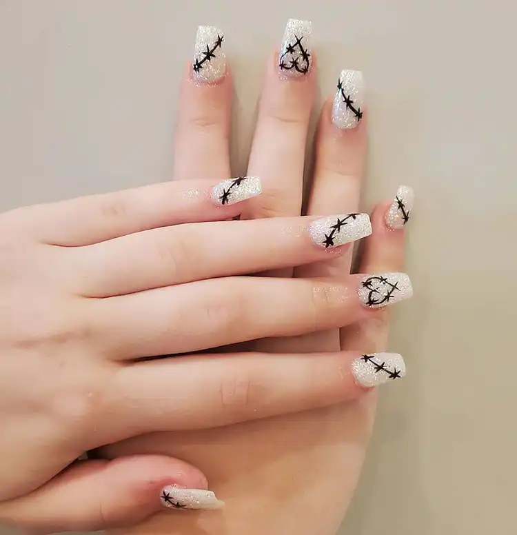Stunning Blue Nail Designs - Perfect Winter Nail Design Ideas 15 White Glitter Nails resembling sparkling snow, a perfect December manicure among stunning blue nail designs and winter ideas.