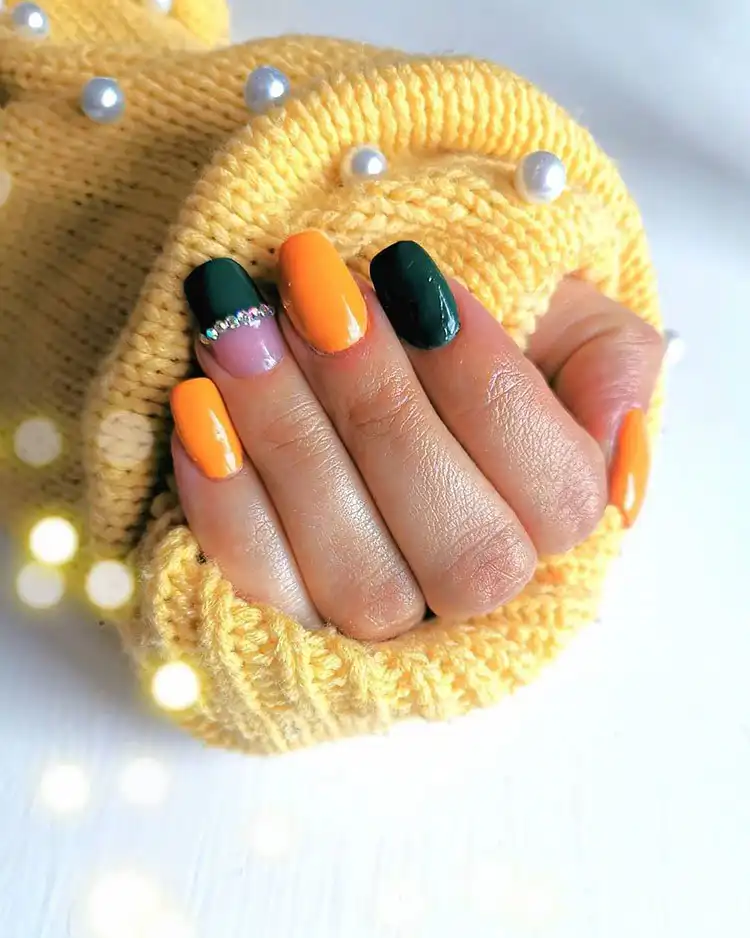Stunning Blue Nail Designs - Perfect Winter Nail Design Ideas 9 Unique Orange and Green nail design with rhinestones, a vibrant choice for winter celebrations, adding to stunning blue nail designs inspiration.