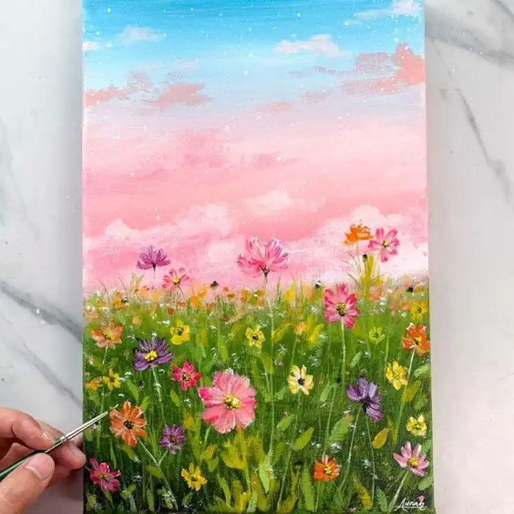 Dreamy flower garden acrylic painting with a vibrant sunset sky background and colorful foreground blossoms.