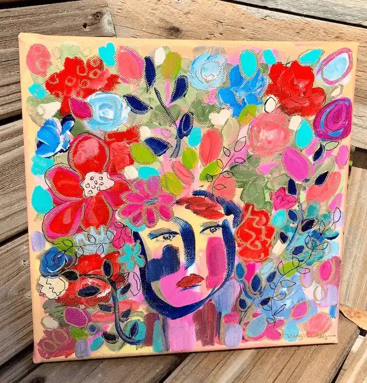 Artistic acrylic painting of a woman with vibrant flowers forming her hair, showcasing delicate beauty.