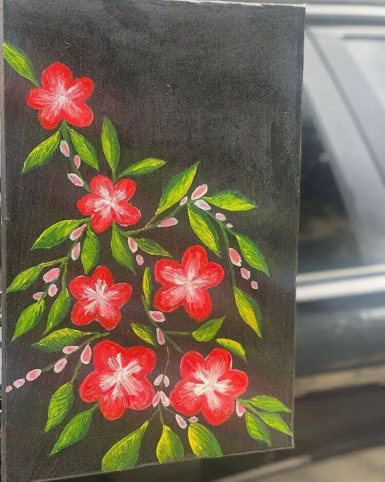 Striking red flowers against a stark black canvas, painted with vibrant acrylics for dramatic effect.