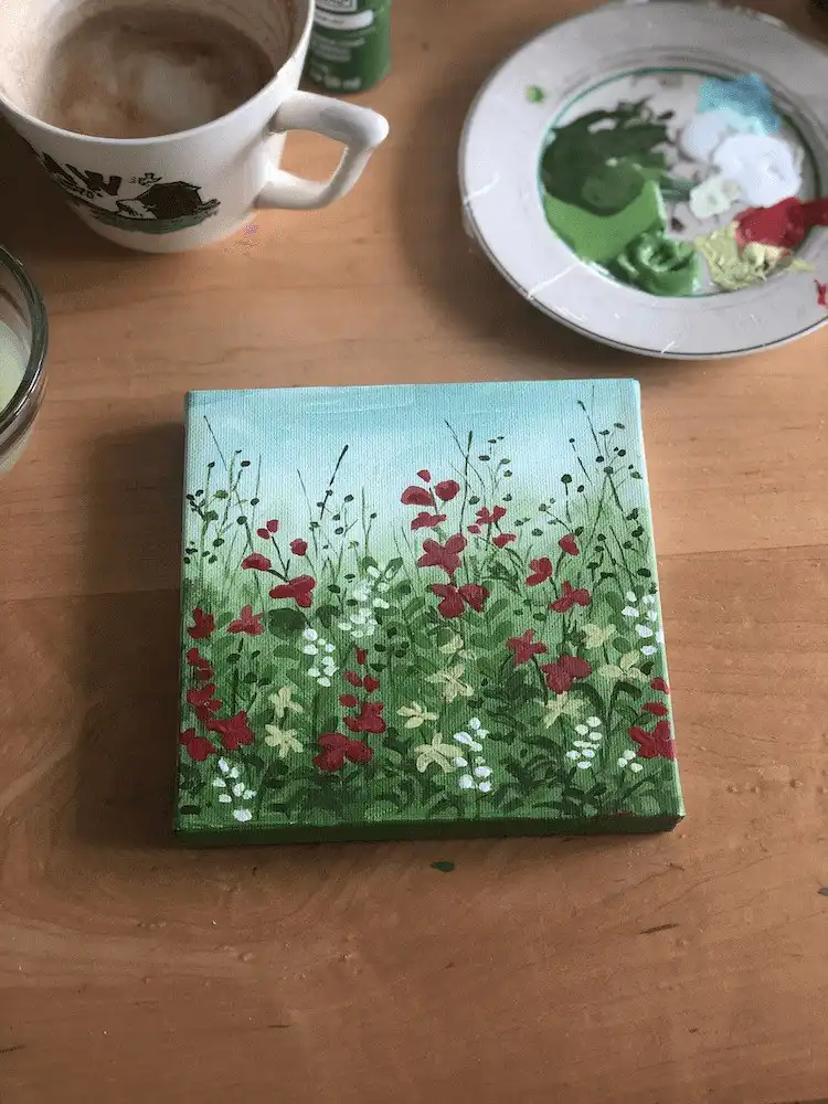 Small wildflower painting, showcasing intricate details of dainty blooms on canvas with vibrant acrylics.