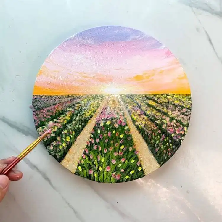 Circular canvas acrylic painting of a colorful tulip field under a pastel sunset sky.