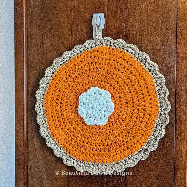 Crochet pumpkin pie potholder in autumn colors