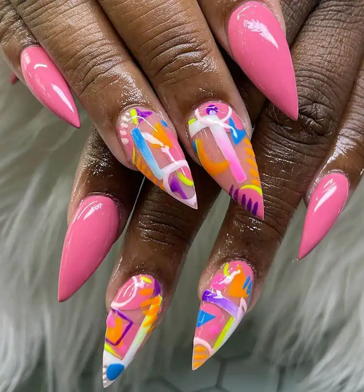 Long, colorful stiletto nails in vibrant hues on dark skin, a bold statement from The Best Nail Designs for Dark Skin Women - Brown Acrylic Nails