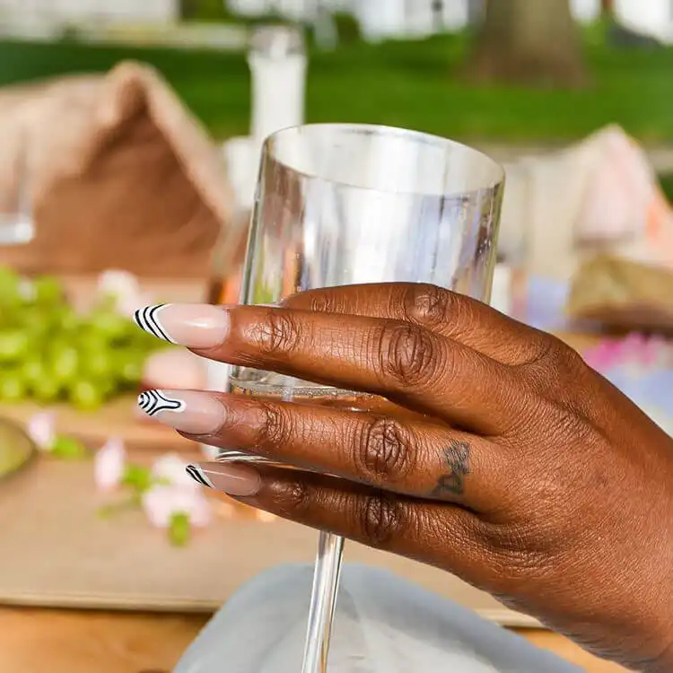 Zebra print applied just to the tips of nails on dark skin, a stylish variation from The Best Nail Designs for Dark Skin Women - Brown Acrylic Nails