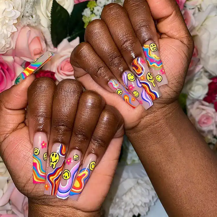 Colorful hippie-inspired nail art with swirls and bright patterns on dark skin, showcasing a creative option for The Best Nail Designs for Dark Skin Women - Brown Acrylic Nails