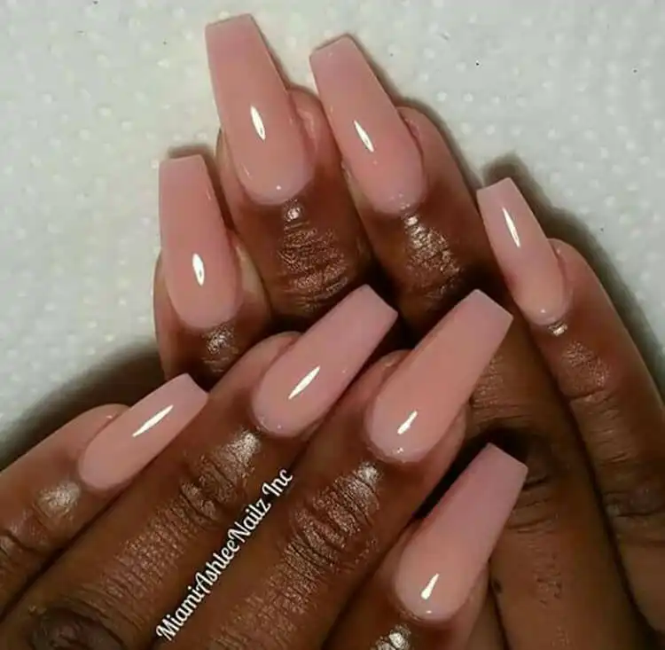 Classic nude colored oval nails perfectly matching dark skin tone, a versatile example from The Best Nail Designs for Dark Skin Women - Brown Acrylic Nails
