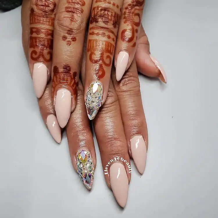 Glamorous rhinestone-encrusted acrylic nails on dark skin, adding sparkle to The Best Nail Designs for Dark Skin Women - Brown Acrylic Nails