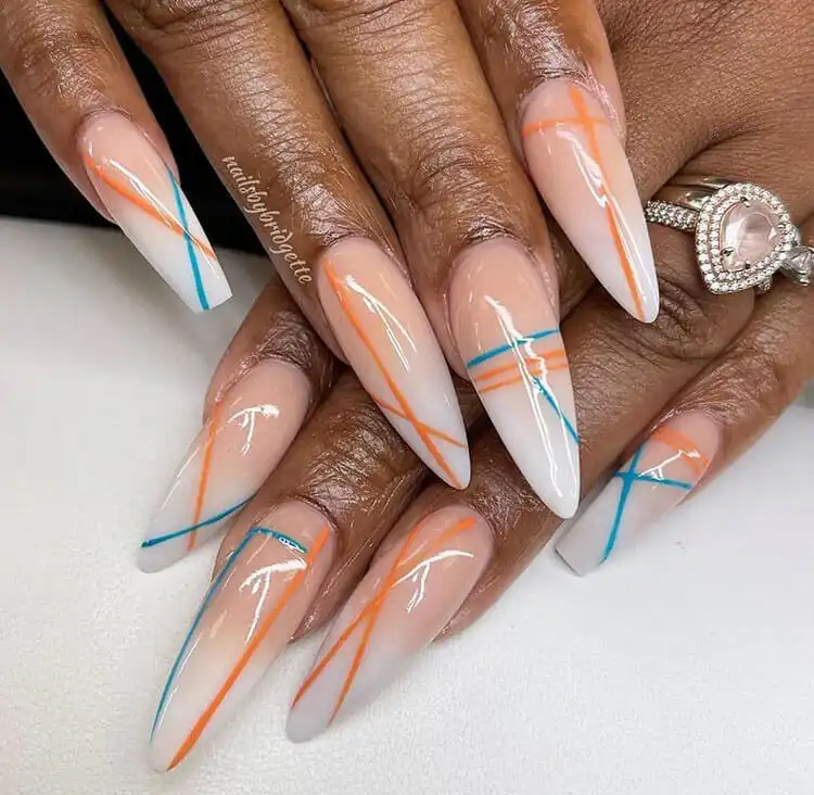 Abstract blue and orange line art on clear nails on dark skin, a modern design from The Best Nail Designs for Dark Skin Women - Brown Acrylic Nails