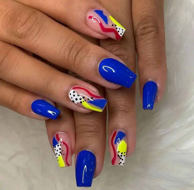 Vibrant abstract nail art with bold colors and shapes on dark skin, a creative design in The Best Nail Designs for Dark Skin Women - Brown Acrylic Nails