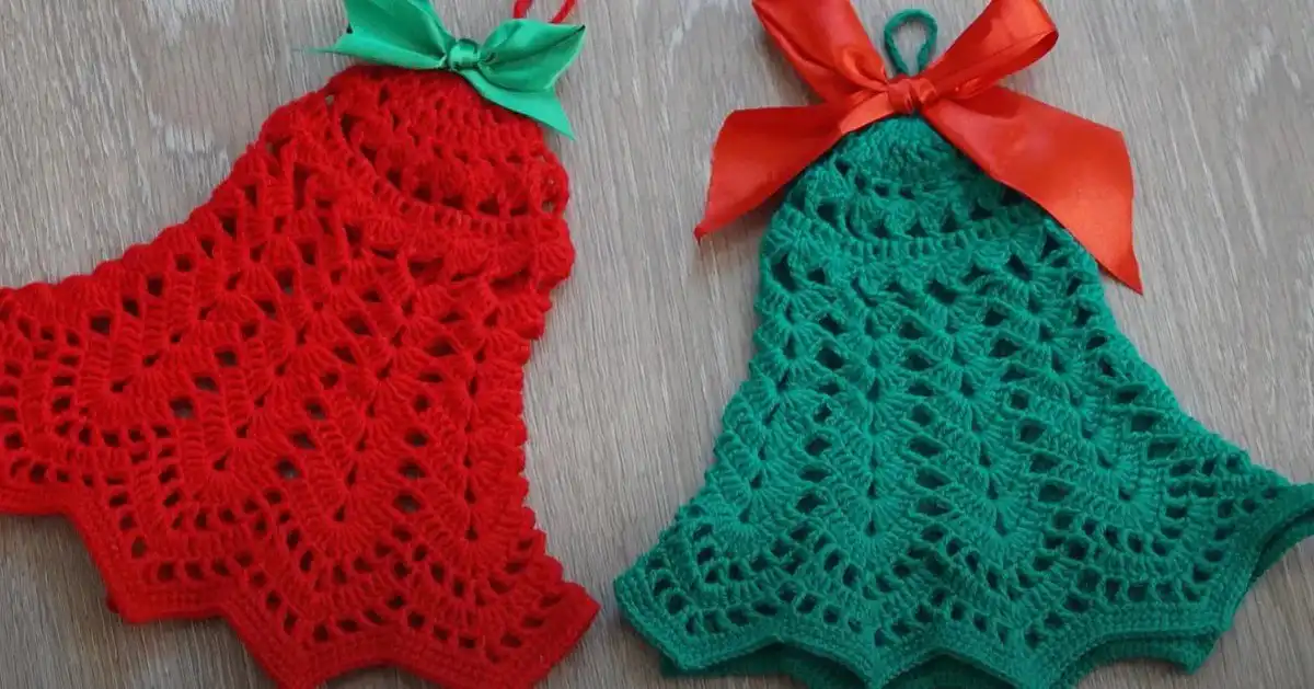 A beautiful collection of handmade crochet Christmas bell decorations in various colors and styles, showcased on a festive tree.