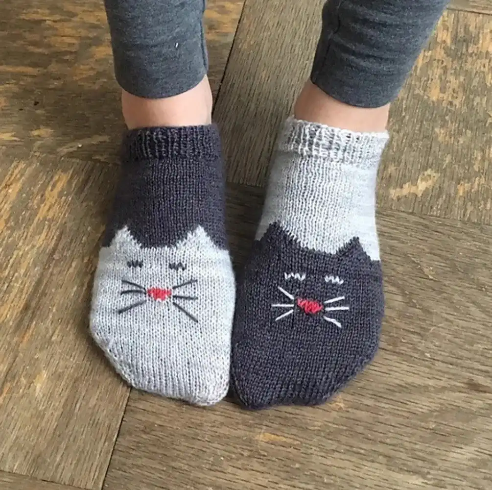 Super chunky knitted bed socks in a soft, light color, highlighting their plush, extra-warm texture, from the Top 10 Free Knitted Socks Patterns.