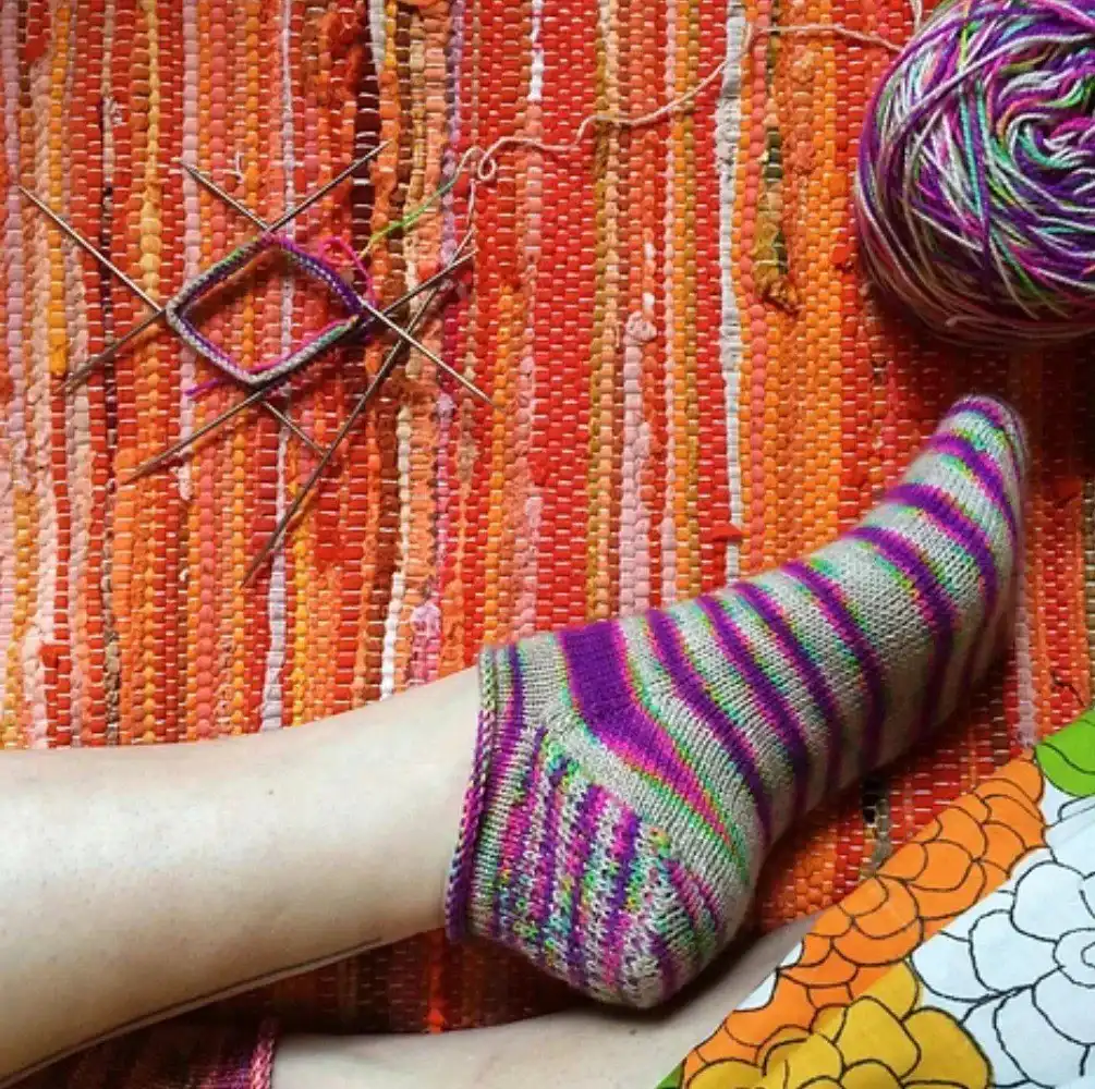 Vibrant striped toe-up knitted socks, displaying colorful sections and seamless construction, from the Top 10 Free Knitted Socks Patterns.