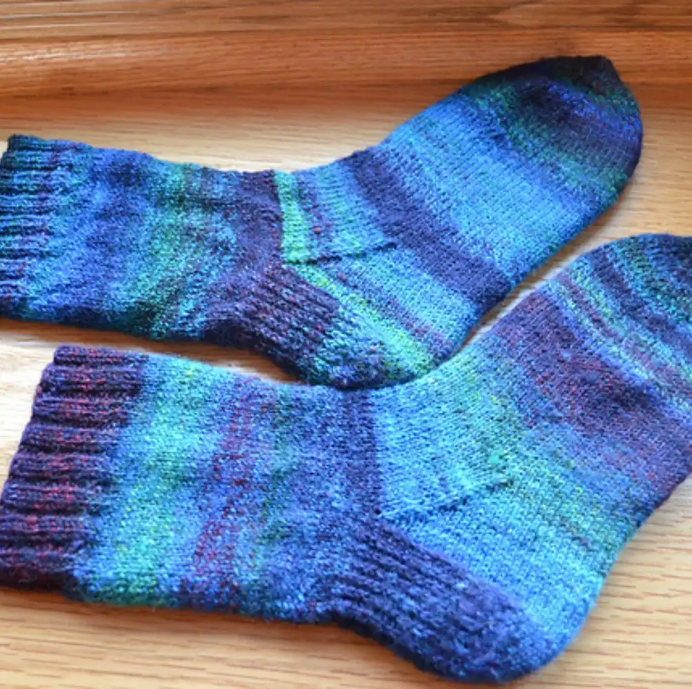 Simple garter stitch slipper socks in a bulky yarn, showing their squishy, comfortable fabric, from the Top 10 Free Knitted Socks Patterns.