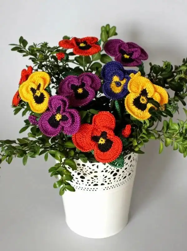 An assortment of simple yet beautiful crochet flowers and leaves in various colors, demonstrating easy embellishment options from the Variety of Flower Appliques Free Crochet Patterns.