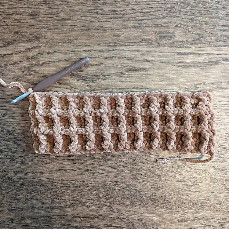 Two finished brown crochet waffle panels laid flat, ready for the butter applique and assembly for the Waffle Pillow Free Crochet Pattern.