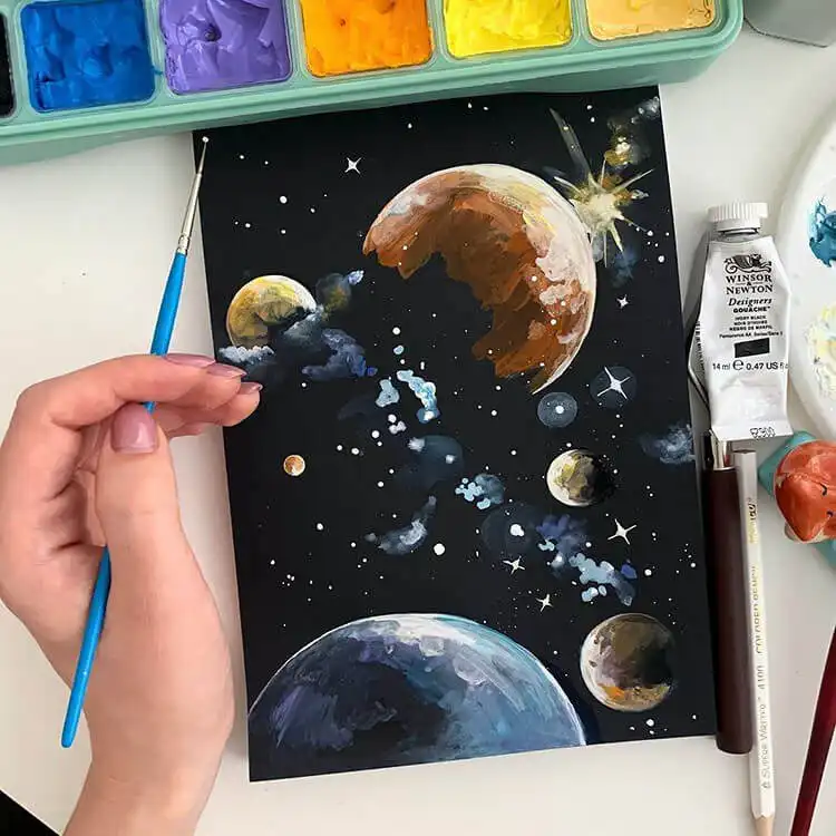 Gouache painting of planets and bold stars against a deep black night sky, illustrating cosmic art.