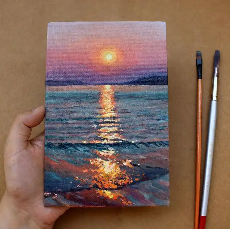 Painting capturing the beautiful colors of a beach sunrise or sunset, with orange and pink hues.