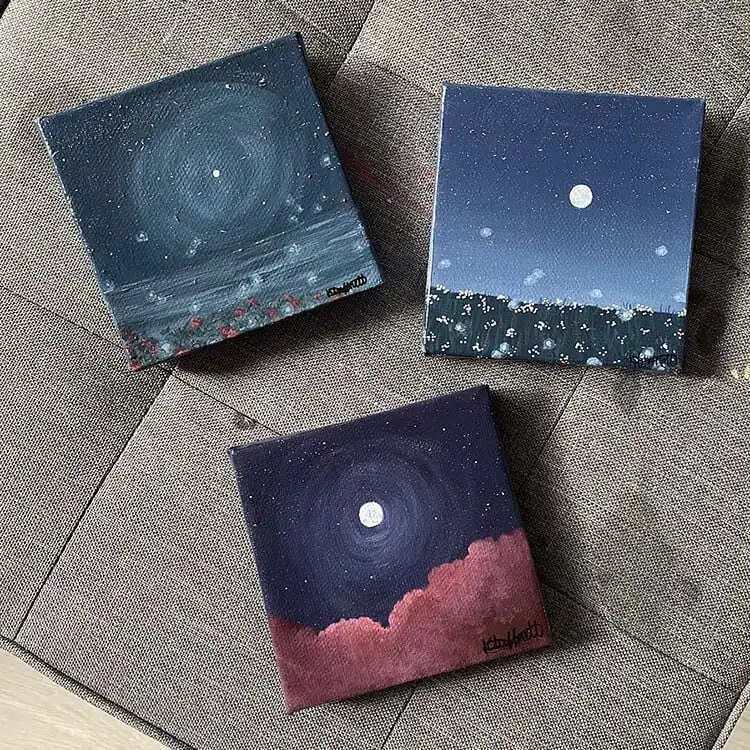 Three small square paintings showcasing different night sky themes, including stars and celestial bodies.