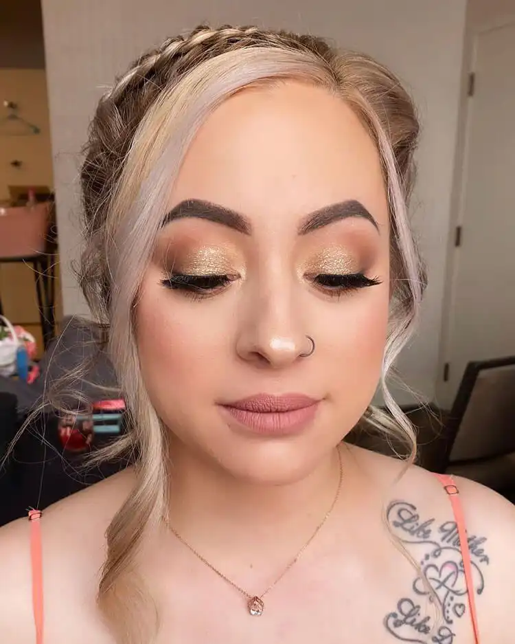 Close-up of a model wearing simple shimmer makeup, highlighting soft, luminous eyeshadow and a natural glow.