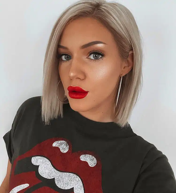 Model's cheek with a touch of berry-toned blush, adding warmth and color to winter complexion.
