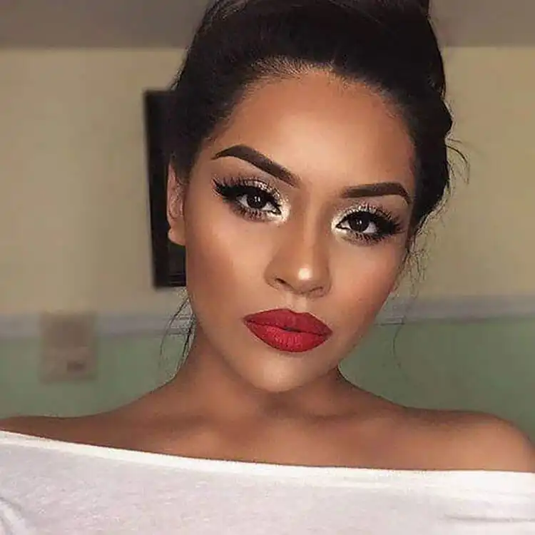 Model wearing classic red lipstick, exuding elegance and timeless beauty for the holidays.