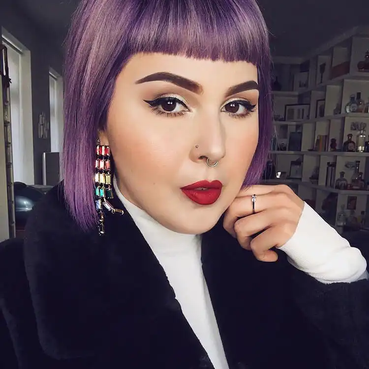 Model showcasing bold berry-toned lips, with a rich plum or burgundy shade.
